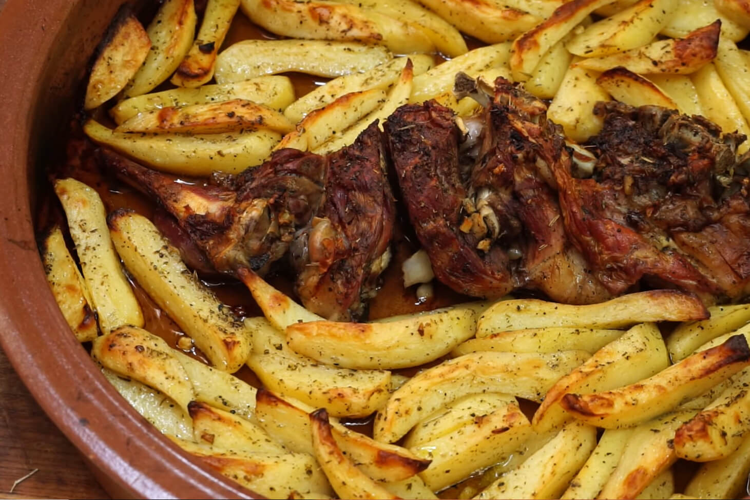 Roast goat with potatoes and lemon in the wood fired oven Amberq